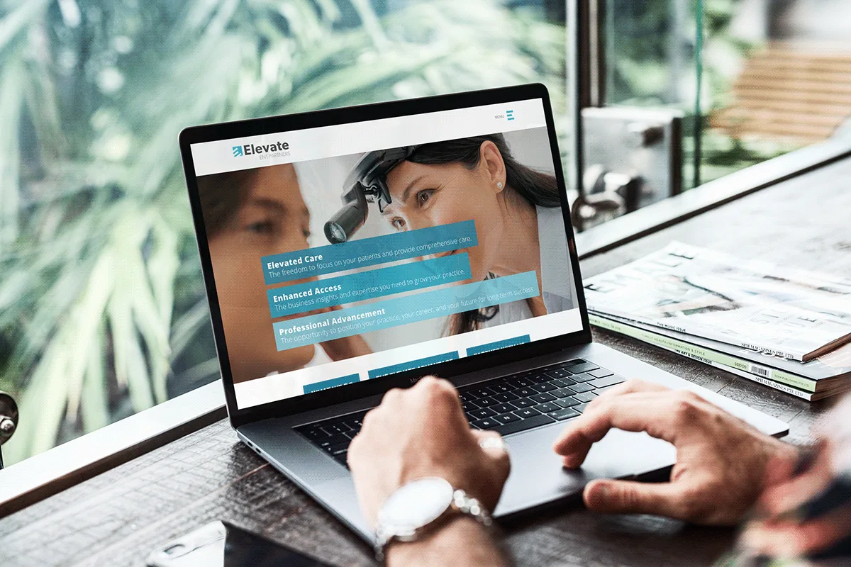 The Elevate Health website open on a laptop.